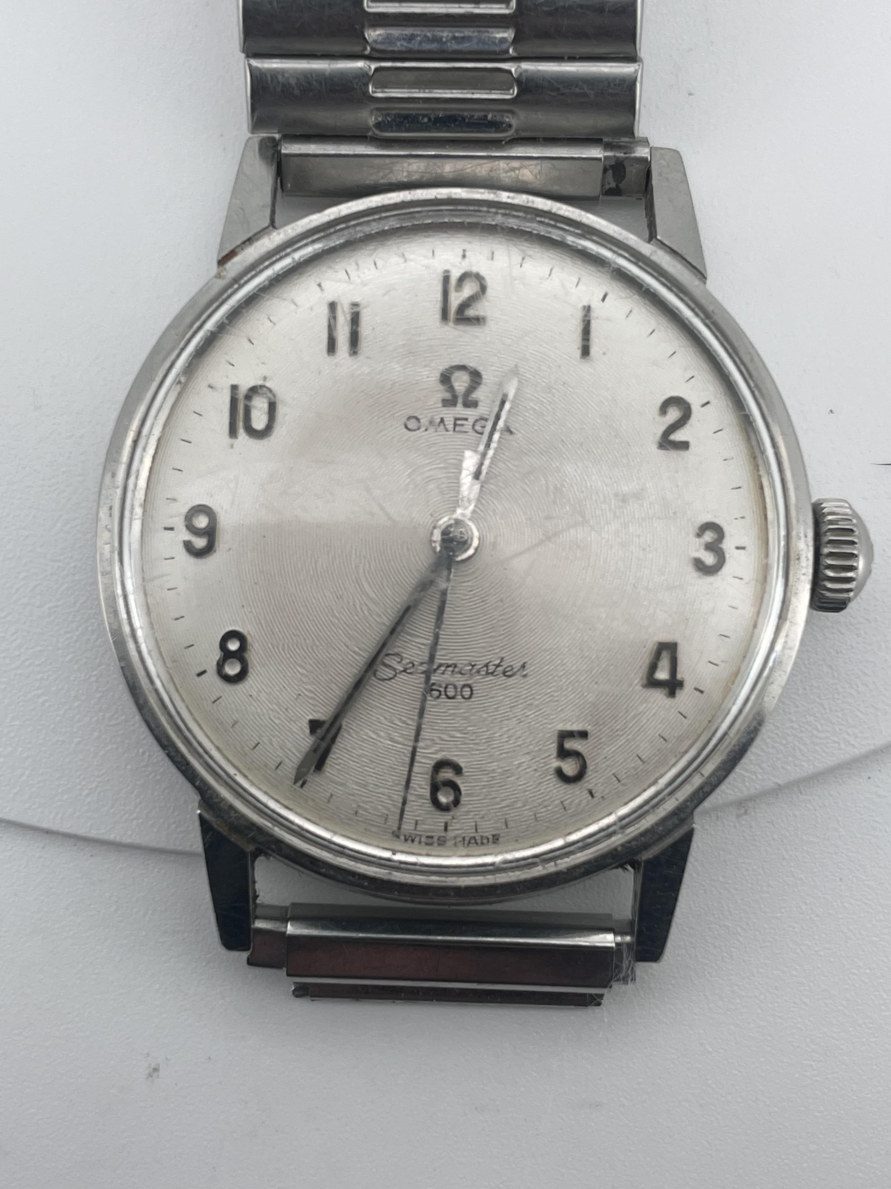 A gentleman’s Omega Seamaster 600 stainless steel automatic wristwatch, silvered engine turned dial with silver Arabic numerals, silvered pencil hands with black insert and centre sweep seconds, case diameter associated
